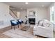 Bright living space with fireplace, hardwood floors, and staircase at 320 Triple Ponds Ct, Clover, SC 29710
