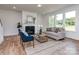 Comfortable living room featuring a fireplace, large windows, and hardwood flooring at 320 Triple Ponds Ct, Clover, SC 29710