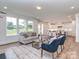 Inviting living room with large windows, a fireplace, and a view into the kitchen at 320 Triple Ponds Ct, Clover, SC 29710