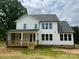 Two-story home with a rear porch, complemented by a spacious backyard and lush green grass at 320 Triple Ponds Ct, Clover, SC 29710