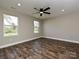 Bedroom with two windows, ceiling fan and hardwood floors at 409 Mint St, Rock Hill, SC 29730