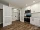 Bright kitchen featuring a pantry, stainless steel appliances, and sleek white cabinetry at 409 Mint St, Rock Hill, SC 29730