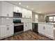 Modern kitchen featuring stainless steel appliances, white cabinetry, and an undermount sink at 409 Mint St, Rock Hill, SC 29730