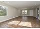 Bright living room featuring hardwood floors, neutral walls, and large windows for natural light at 409 Mint St, Rock Hill, SC 29730