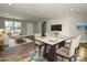 Open-concept living room featuring hardwood floors, neutral paint, modern furniture, and bright natural light at 409 Mint St, Rock Hill, SC 29730