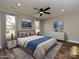 Inviting staged bedroom with two windows, ceiling fan, lamps, and decorative wall art at 409 Mint St, Rock Hill, SC 29730