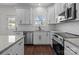 White kitchen with stainless steel appliances and granite countertops at 635 E Ridge Rd, Salisbury, NC 28144