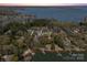 Aerial view of lakefront property with mature trees, private docks, and houses surrounded by water at 8039 Mcconnell Rd, Denver, NC 28037