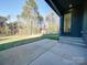 View of the back patio leading to the sprawling backyard and a glimpse of the building's dark exterior at 8039 Mcconnell Rd, Denver, NC 28037