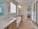 Bright bathroom with a free-standing tub, double vanity, and bedroom view at 8039 Mcconnell Rd, Denver, NC 28037