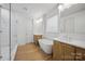 Elegant bathroom with soaking tub, double vanity, and walk-in shower at 8039 Mcconnell Rd, Denver, NC 28037