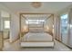 Bright bedroom featuring a four-poster bed and a view of the outside at 8039 Mcconnell Rd, Denver, NC 28037