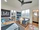 Charming bedroom with two twin beds, fun decor, and a connecting bathroom for convenience at 8039 Mcconnell Rd, Denver, NC 28037