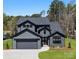 Modern two-story home featuring a gray exterior, attached garage, and manicured landscaping at 8039 Mcconnell Rd, Denver, NC 28037