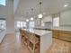 Spacious kitchen island with white countertop, pendant lighting, and seating, perfect for dining and entertaining at 8039 Mcconnell Rd, Denver, NC 28037