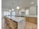 Spacious kitchen island with white countertop, pendant lighting, and seating, showcasing modern design at 8039 Mcconnell Rd, Denver, NC 28037