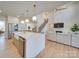 Bright, open-concept kitchen featuring an island, stainless steel appliances, and a view into the living room at 8039 Mcconnell Rd, Denver, NC 28037