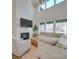 Bright living room featuring high ceilings, a fireplace and a large sectional sofa at 8039 Mcconnell Rd, Denver, NC 28037