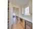 Walk-in pantry with custom shelving, built-in microwave, and wine refrigerator, designed for easy storage at 8039 Mcconnell Rd, Denver, NC 28037
