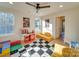 Playroom with a red checkout counter, checkerboard rug, and yellow couches at 8039 Mcconnell Rd, Denver, NC 28037