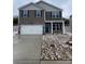 Charming two-story home with a stone and gray facade, blue shutters, and a two-car garage at 108 Rustling Waters Dr, Mooresville, NC 28117