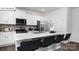 Modern kitchen boasts stainless steel appliances, white cabinets and an expansive island with bar seating at 108 Rustling Waters Dr, Mooresville, NC 28117