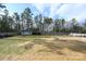 Large backyard with a shed, fire pit, and fenced perimeter at 1274 Bicycle Ct, York, SC 29745