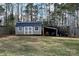 Tan shed with black roof and a covered area next to it at 1274 Bicycle Ct, York, SC 29745