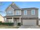 Two-story house with gray siding, brick accents, and a two-car garage at 188 Water Ski Dr, Statesville, NC 28677