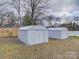 Two storage sheds in backyard with mature trees at 221 Palmer St, Albemarle, NC 28001