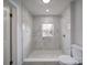 Updated bathroom with marble shower surround and pebble floor at 221 Palmer St, Albemarle, NC 28001