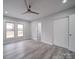 Bright bedroom with ceiling fan, gray flooring, and double door closet at 221 Palmer St, Albemarle, NC 28001