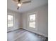 Spacious bedroom featuring wood-look floors and large windows at 221 Palmer St, Albemarle, NC 28001