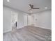 Bedroom with ceiling fan, gray flooring, and en-suite bathroom access at 221 Palmer St, Albemarle, NC 28001