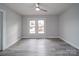 Well-lit bedroom with ceiling fan and gray vinyl flooring at 221 Palmer St, Albemarle, NC 28001