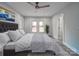 Main bedroom with ceiling fan, gray flooring, and plenty of natural light at 221 Palmer St, Albemarle, NC 28001