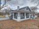 Renovated home showcasing side yard and landscaping at 221 Palmer St, Albemarle, NC 28001