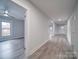 Bright hallway with gray vinyl flooring and access to multiple rooms at 221 Palmer St, Albemarle, NC 28001