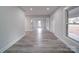 Bright hallway with hardwood floors and access to rooms at 221 Palmer St, Albemarle, NC 28001