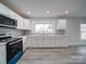 Modern kitchen with white cabinets and teal appliances at 221 Palmer St, Albemarle, NC 28001