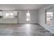 Bright kitchen with white cabinets, gray vinyl flooring, and a view to the dining area at 221 Palmer St, Albemarle, NC 28001