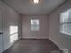 Simple bedroom with wood-look floors and a window at 2996 Shady Ln, Charlotte, NC 28208