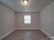 Bright bedroom with hardwood floors and window at 2996 Shady Ln, Charlotte, NC 28208