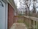 Wooden deck overlooking backyard with trees at 2996 Shady Ln, Charlotte, NC 28208