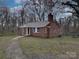 Red brick house with a front yard and walkway at 2996 Shady Ln, Charlotte, NC 28208