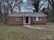 Red brick ranch house with a front door and yard at 2996 Shady Ln, Charlotte, NC 28208