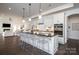 A modern, open-concept kitchen with sleek black countertops, white cabinets, and barstool seating at 3013 Old Glory Dr # 24, Gastonia, NC 28056