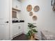 A modern laundry room with white cabinets, granite countertop, decorative wall baskets, and plant at 3013 Old Glory Dr # 24, Gastonia, NC 28056