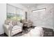 Cozy sitting room with gray chairs, marble accent wall, bright natural light, and dark wood floors at 3013 Old Glory Dr # 24, Gastonia, NC 28056