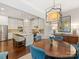 Elegant dining room features a wood table and blue velvet chairs at 3364 Northampton Dr, Charlotte, NC 28210